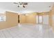 Bright living space featuring neutral walls, tiled floors, ceiling fan, and chandelier lighting at 7812 Wicklow Cir, Orlando, FL 32817