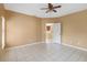 Neutral living room with tile flooring and view to kitchen at 7812 Wicklow Cir, Orlando, FL 32817