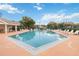 A refreshing community pool with lounge chairs, tables and chairs, and shaded seating area is available at 7812 Wicklow Cir, Orlando, FL 32817