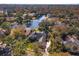 Aerial view of house, pool, and surrounding landscape near lake at 812 Edgeforest Ter, Sanford, FL 32771