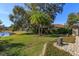 Landscaped backyard featuring a stone water feature and lush greenery at 812 Edgeforest Ter, Sanford, FL 32771