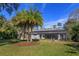 House exterior showcasing a covered patio and lush landscaping at 812 Edgeforest Ter, Sanford, FL 32771