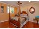 Charming bedroom with a large wooden four poster bed and hardwood floors at 812 Edgeforest Ter, Sanford, FL 32771