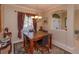 Bright dining room features a dark wood table with four chairs and decorative rug at 812 Edgeforest Ter, Sanford, FL 32771