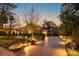 Stunning home exterior at dusk, featuring a brick driveway and professionally landscaped front yard at 812 Edgeforest Ter, Sanford, FL 32771