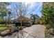 Charming home with landscaped grounds and a brick driveway, showcasing curb appeal and elegance at 812 Edgeforest Ter, Sanford, FL 32771