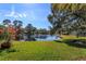 Scenic lakefront view with a tranquil atmosphere and blooming flowers at 812 Edgeforest Ter, Sanford, FL 32771