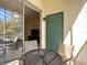 Small balcony with patio furniture and access to interior at 8908 Legacy Ct # 201, Kissimmee, FL 34747