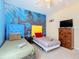 Bedroom with two twin beds, ocean mural, and dresser at 8908 Legacy Ct # 201, Kissimmee, FL 34747