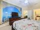 Bedroom with beach mural, king-size bed and view into dining area at 8908 Legacy Ct # 201, Kissimmee, FL 34747