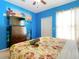 Bedroom with TV, dresser, and floral bedding at 8908 Legacy Ct # 201, Kissimmee, FL 34747