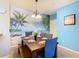 Tropical dining area featuring a beach mural and wooden table at 8908 Legacy Ct # 201, Kissimmee, FL 34747