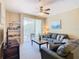 Living room with gray couch and access to balcony at 8908 Legacy Ct # 201, Kissimmee, FL 34747