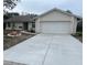 Single-story house with attached garage and landscaped front yard at 9142 Sabal Palm Cir, Windermere, FL 34786