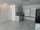 Open kitchen with gray cabinets, marble floors, and new appliances at 9142 Sabal Palm Cir, Windermere, FL 34786