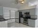 Spacious kitchen with stainless steel appliances and marble-look floors at 9142 Sabal Palm Cir, Windermere, FL 34786