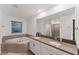 Elegant bathroom featuring a corner soaking tub and dual vanities at 11836 Language Way, Orlando, FL 32832