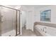 Clean bathroom with a large shower and a corner bathtub at 11836 Language Way, Orlando, FL 32832