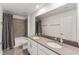 Bathroom with double vanity, tub, and gray tile at 11836 Language Way, Orlando, FL 32832