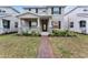 Two-story house with gray siding, brick accents, and a landscaped front yard at 11836 Language Way, Orlando, FL 32832