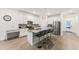 Modern kitchen with white cabinets, stainless steel appliances, and an island at 11836 Language Way, Orlando, FL 32832