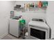 Laundry room with washer, dryer, and shelving at 11836 Language Way, Orlando, FL 32832