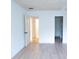 Bedroom features new light wood flooring and an open closet at 100 El Camino Dr # 102, Winter Haven, FL 33884
