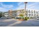 Multi-story condo building with balconies, covered parking, and well-maintained landscaping at 100 El Camino Dr # 102, Winter Haven, FL 33884
