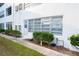 A clean white building exterior with large windows and green landscaping at 100 El Camino Dr # 102, Winter Haven, FL 33884