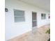 Exterior showing a clean white facade with windows and secured entryway at 100 El Camino Dr # 102, Winter Haven, FL 33884