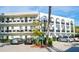 A bright, white condo building showcasing an interesting architectural design and carport parking at 100 El Camino Dr # 102, Winter Haven, FL 33884
