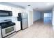Bright kitchen features stainless steel appliances and white cabinets at 100 El Camino Dr # 102, Winter Haven, FL 33884
