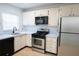 A functional kitchen features a stainless steel oven, microwave, and refrigerator at 100 El Camino Dr # 102, Winter Haven, FL 33884