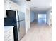 Spacious living room featuring updated light laminate floors and bright white walls at 100 El Camino Dr # 102, Winter Haven, FL 33884