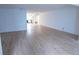 Open-concept layout showcases new light wood floors, connecting living spaces at 100 El Camino Dr # 102, Winter Haven, FL 33884