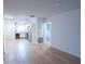 Bright living room open to kitchen with modern appliances and wood-look floors creating a welcoming and functional space at 100 El Camino Dr # 102, Winter Haven, FL 33884