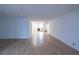 Open living area with light wood floors leads to the kitchen at 100 El Camino Dr # 102, Winter Haven, FL 33884