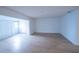 Spacious living room features light wood floors and natural lighting at 100 El Camino Dr # 102, Winter Haven, FL 33884