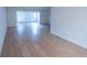 Bright living room boasts new light wood flooring and ample natural light at 100 El Camino Dr # 102, Winter Haven, FL 33884