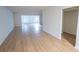 Large, open-concept living room with wood-look floors and natural light is ready for personalization at 100 El Camino Dr # 102, Winter Haven, FL 33884