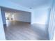 Open-concept living room features a view of the kitchen and light wood flooring at 100 El Camino Dr # 102, Winter Haven, FL 33884