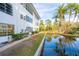 Beautiful water view with palm trees reflecting in the water, next to the building at 100 El Camino Dr # 102, Winter Haven, FL 33884