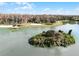 Picturesque aerial view of a lake with an island, a pier, a beach, and recreation areas at 1068 Park Ridge Cir, Kissimmee, FL 34746