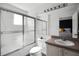 Clean bathroom featuring a shower-tub combination with glass doors and ample counter space at 1068 Park Ridge Cir, Kissimmee, FL 34746