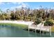 A sandy beach with a pier borders a lovely, green lake at 1068 Park Ridge Cir, Kissimmee, FL 34746