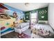 Whimsical bedroom featuring twin beds and a vibrant Disney-themed mural on the wall at 1068 Park Ridge Cir, Kissimmee, FL 34746