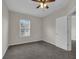 Well-lit bedroom with ceiling fan and carpet flooring at 1076 Taramundi Dr, Oviedo, FL 32765