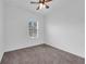 Simple bedroom with window, ceiling fan and carpet at 1076 Taramundi Dr, Oviedo, FL 32765