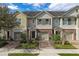 Three-story townhouses with attached garages and landscaped yards at 1076 Taramundi Dr, Oviedo, FL 32765