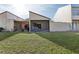 Backyard view of the home with green grass and a screened patio at 109 Madrid Dr # 109, Casselberry, FL 32707